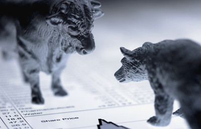Bull and bear figurines on list of share prices